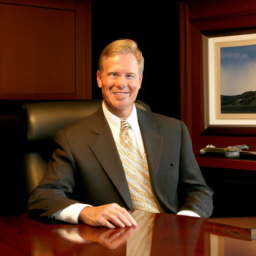 Description: A picture of Summit Investment Management's new managing director, Jeff Feit, sitting at a desk.