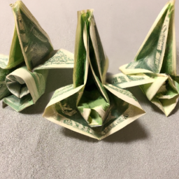 description: three origami dollar flowers in a row.