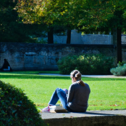 description: a person sitting in a peaceful park, reading a book and enjoying the sunshine.