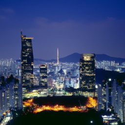 description: A photo of a city skyline with tall buildings and bright lights at night. The name of the city is not specified.