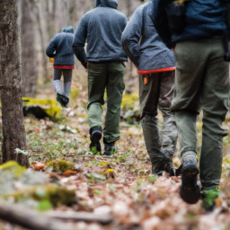 a group of hikers wearing cqr water-resistant hiking pants are seen trekking through a forest. the pants are made with durable materials and feature cargo pockets for storing essentials.