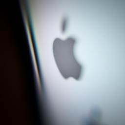 description: a close-up of an iphone screen with the apple logo visible in the background.