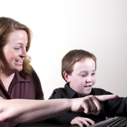 an image of a parent and child sitting at a table, looking at a computer screen and discussing investing. the child looks engaged and interested, while the parent is smiling and pointing to something on the screen.