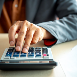 a person using a calculator, symbolizing the use of dividend calculators in investment analysis.
