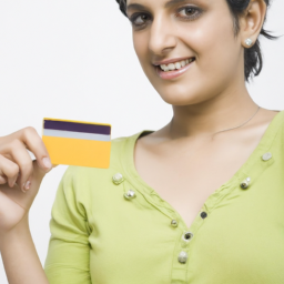 A person holding a credit card and smiling