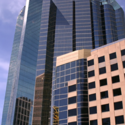 description: a photo of a modern commercial building with glass windows and a sleek design. the building is located in a bustling downtown area with other tall buildings in the background.